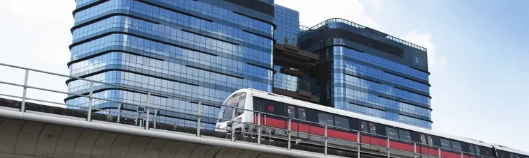 MRT train passing the Woods Square towers in Woodlands